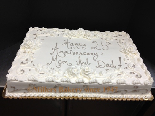 Simple Yet Elegant Full Sheet Wedding Anniversary .25th Silver Anniversary Full Sheet Cake Serves 100,Decorated With All White Roses Throughout With Silver Piping Scroll Work Along The Borders And Sides.Understated And Will Not Break The Bank.